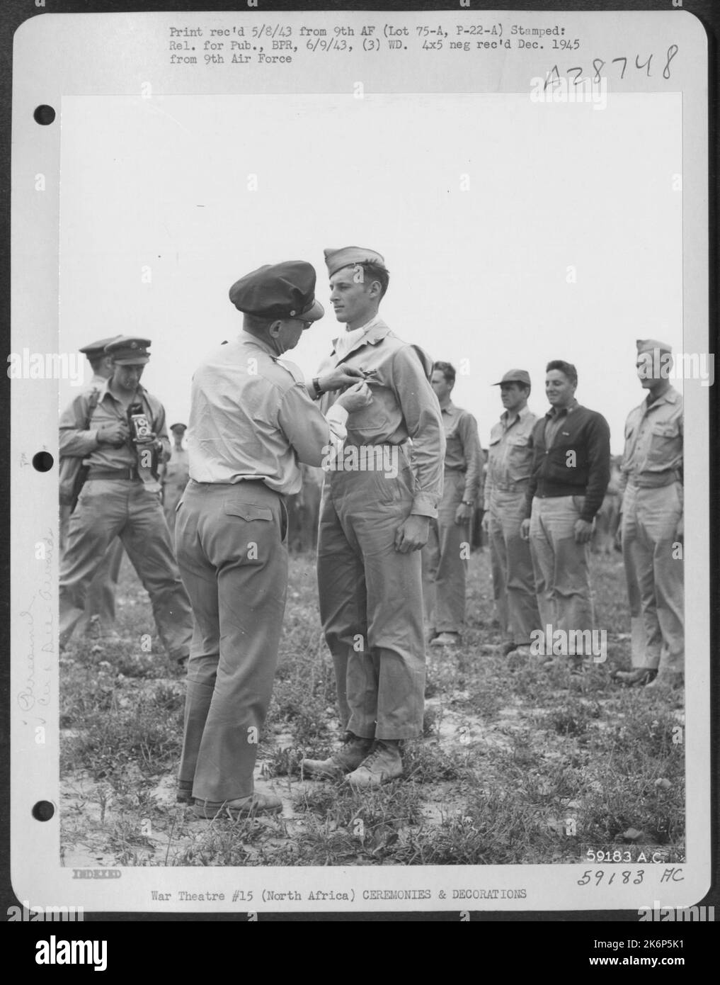 2nd Lt. Dale R. Deniston, Akron, Ohio, receiving the Distinguished Flying Cross from Maj. Gen. Lewis H. Brereton. NORTH AFRICA. Stock Photo