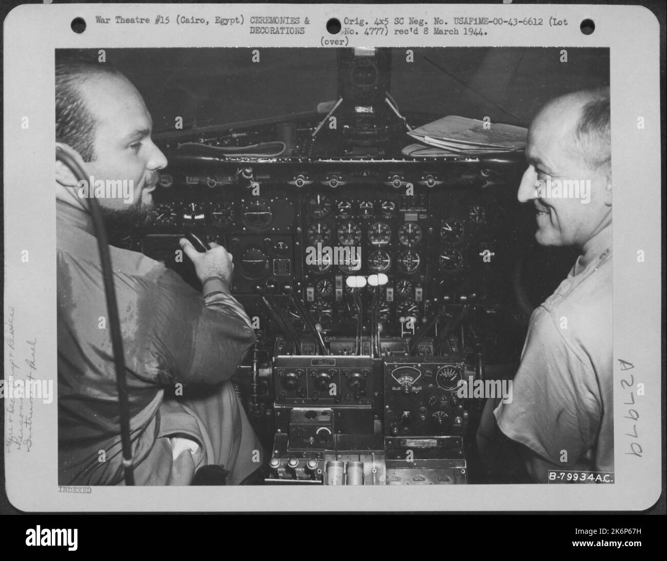 King Farouk of Egypt listens with interest as Major General Ralph Royce explains the operation of a Consolidated B-24 during the King's visit to John Payne Field, Cairo, Egypt on 23 September 1943. Stock Photo