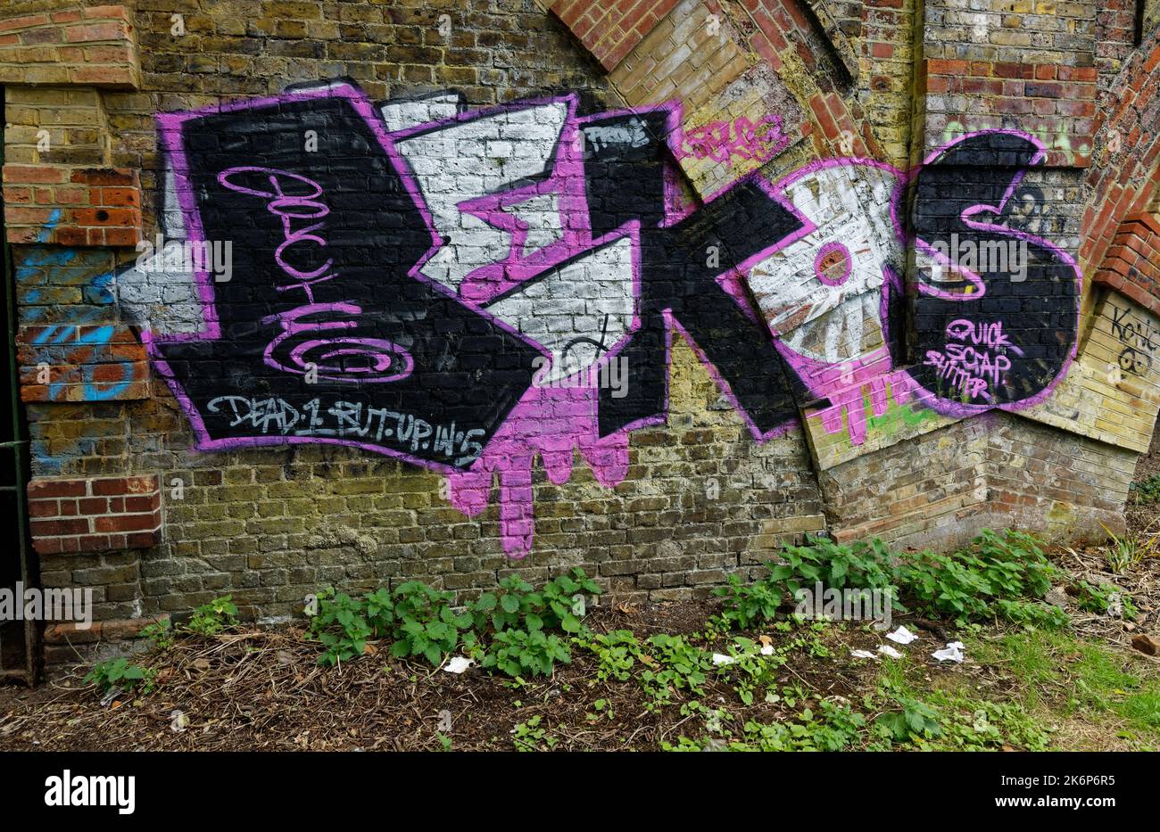 Graffiti is street art or vandalism, a big debate, on a railway arch by Richmond-Upon-Thames riverside, London, England Stock Photo