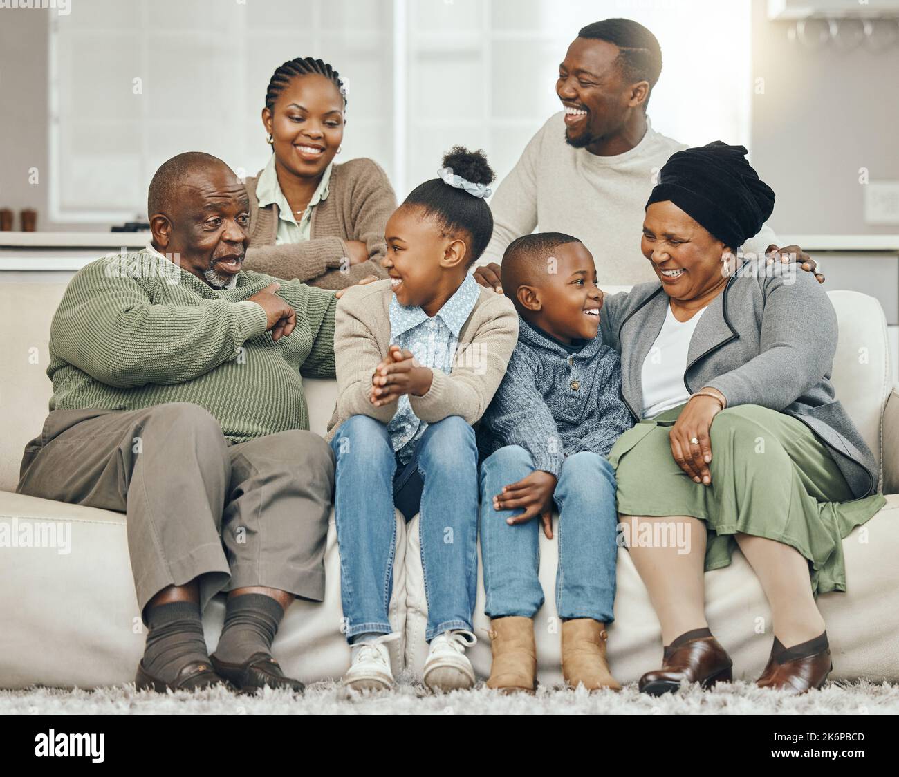 Whose making the tea. a family bonding on a sofa at home. Stock Photo