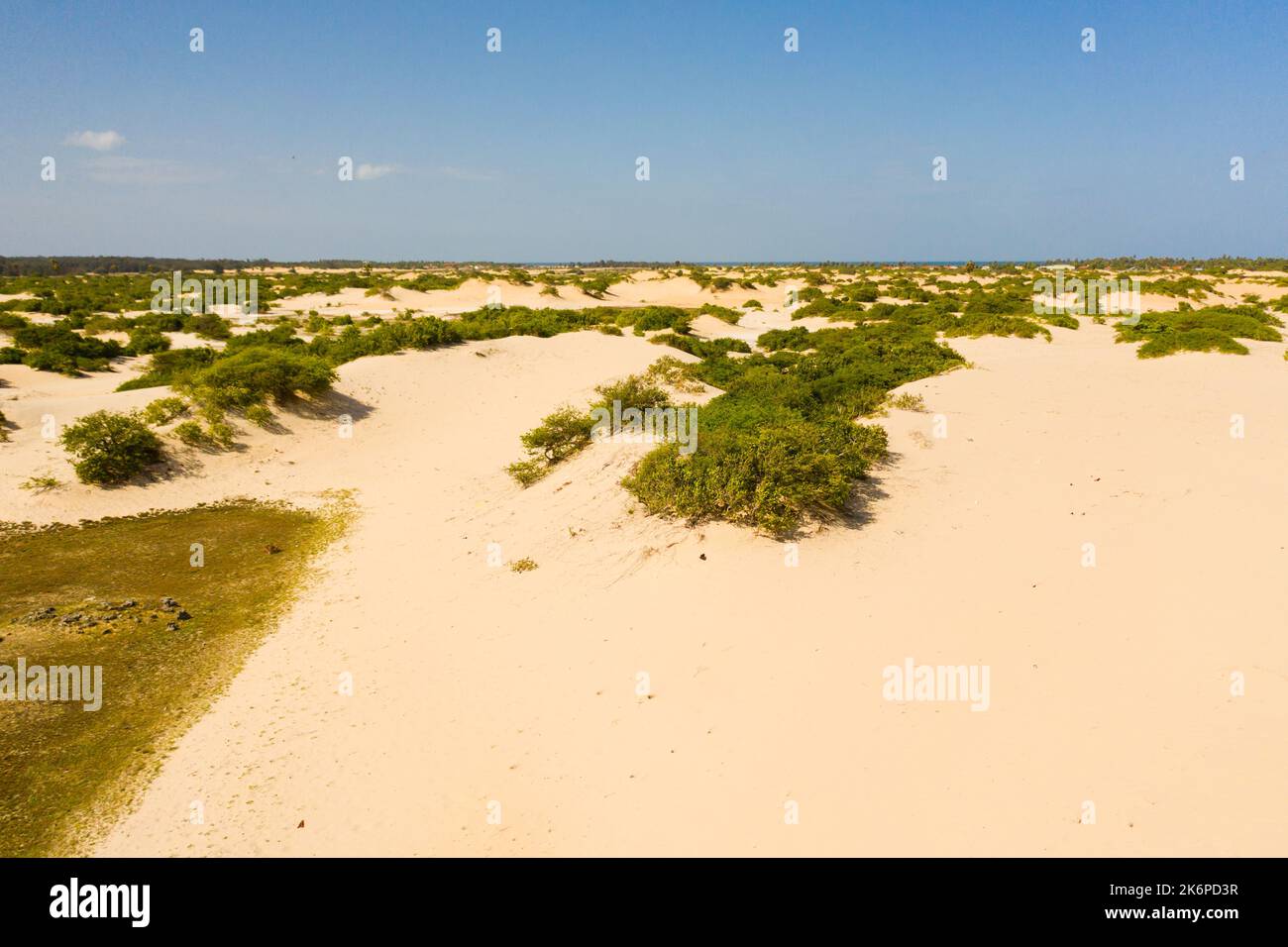 A desert area with sand hills and dunes next to the ocean. Manalkaadu ...