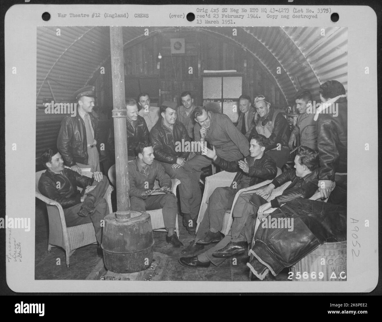 "You should have seen the one that got away," says Capt. Irl E. Baldwin of Yakima, Washington, pilot of the Boeing B-17 "HELLS ANGELS," as he and his flight crew relate their experiences on their 28th mission to the ground crew at their base Stock Photo