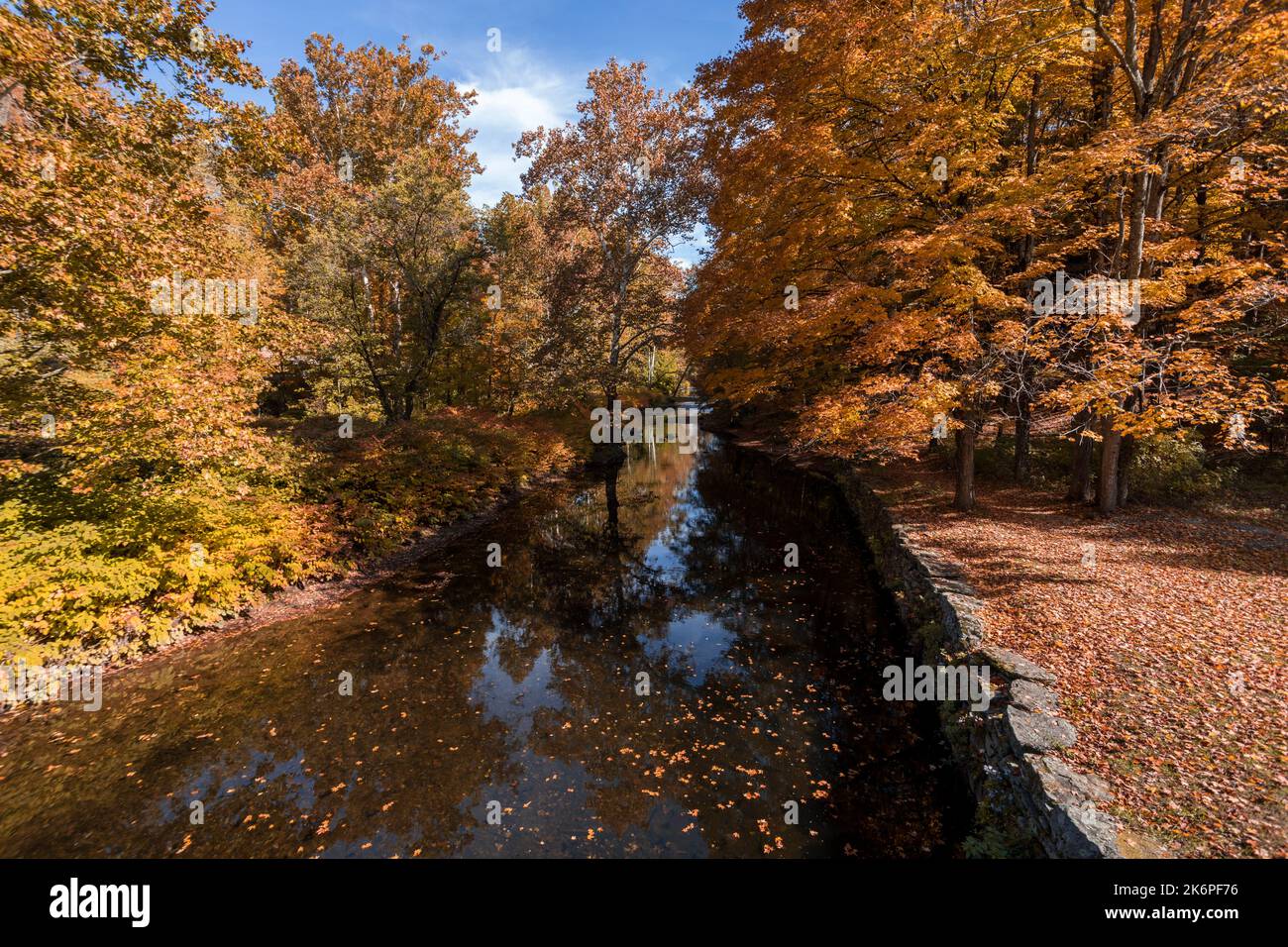 Stone Arch Bridge in Callicoon, NY, Catskill Mountains, surrounded by brilliant fall foliage on a bright autumn morning Stock Photo