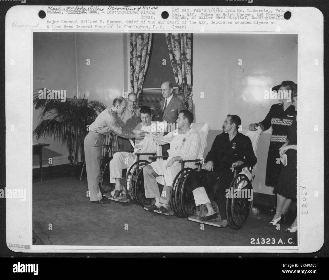 Major General Millard F. Harmon, Chief of the Air Staff of the Army Air forces, decorates wounded flyers at Walter Reed General Hospital in Washington, D.C. Left to right, General Harmon, Brig. Gen. James H. Doolittle, 1st Lt. Charles L. McClure Stock Photo