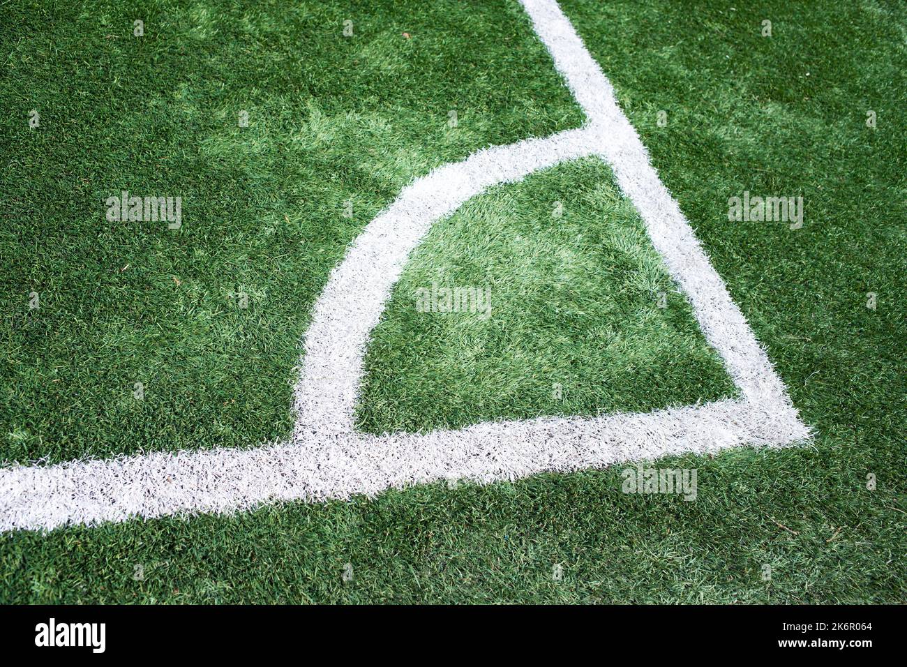 Corner of a soccer fied in a bright sunny day. Artificial grass with