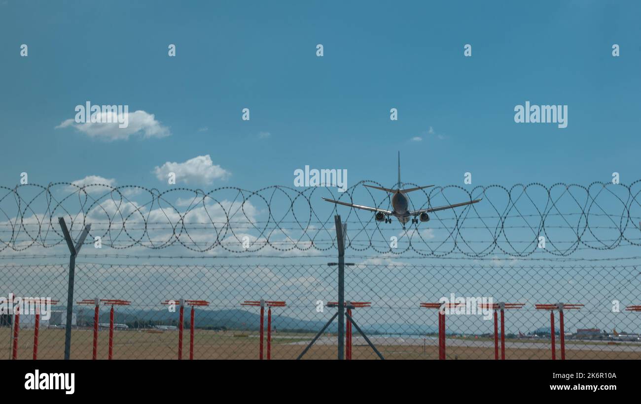 Airplane flying in a blue sky Stock Photo - Alamy