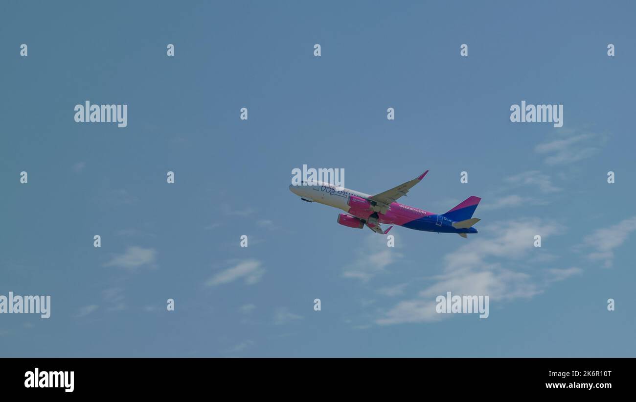 Airplane flying in a blue sky Stock Photo - Alamy