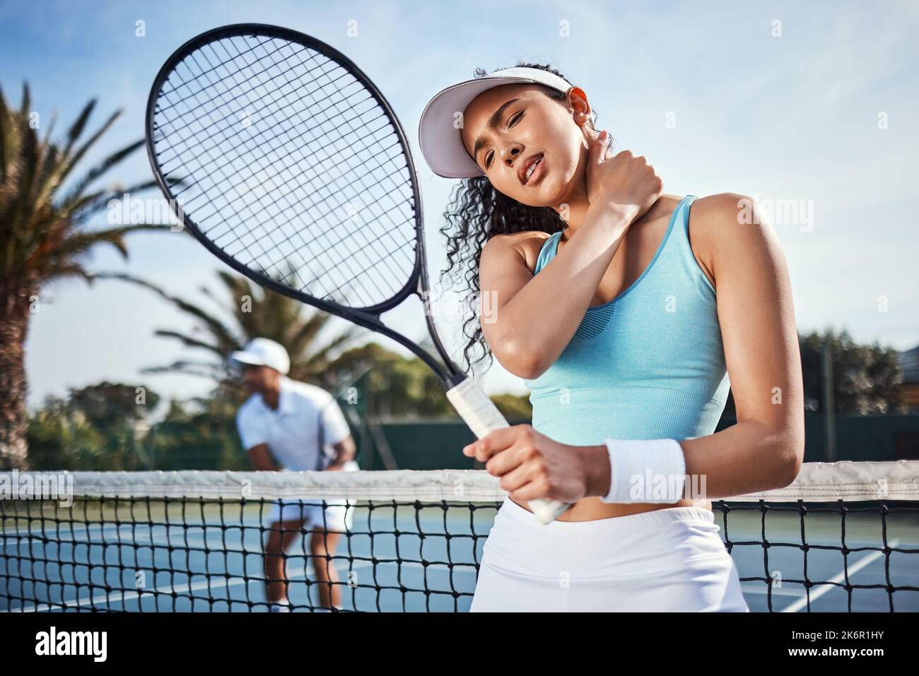 Ouch. an attractive young woman suffering from a neck injury during
