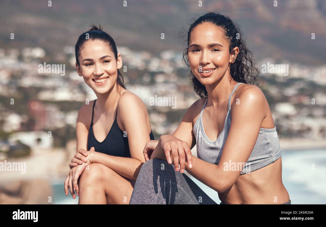 Taking a moment to catch our breath. two young friends taking a break during a workout. Stock Photo