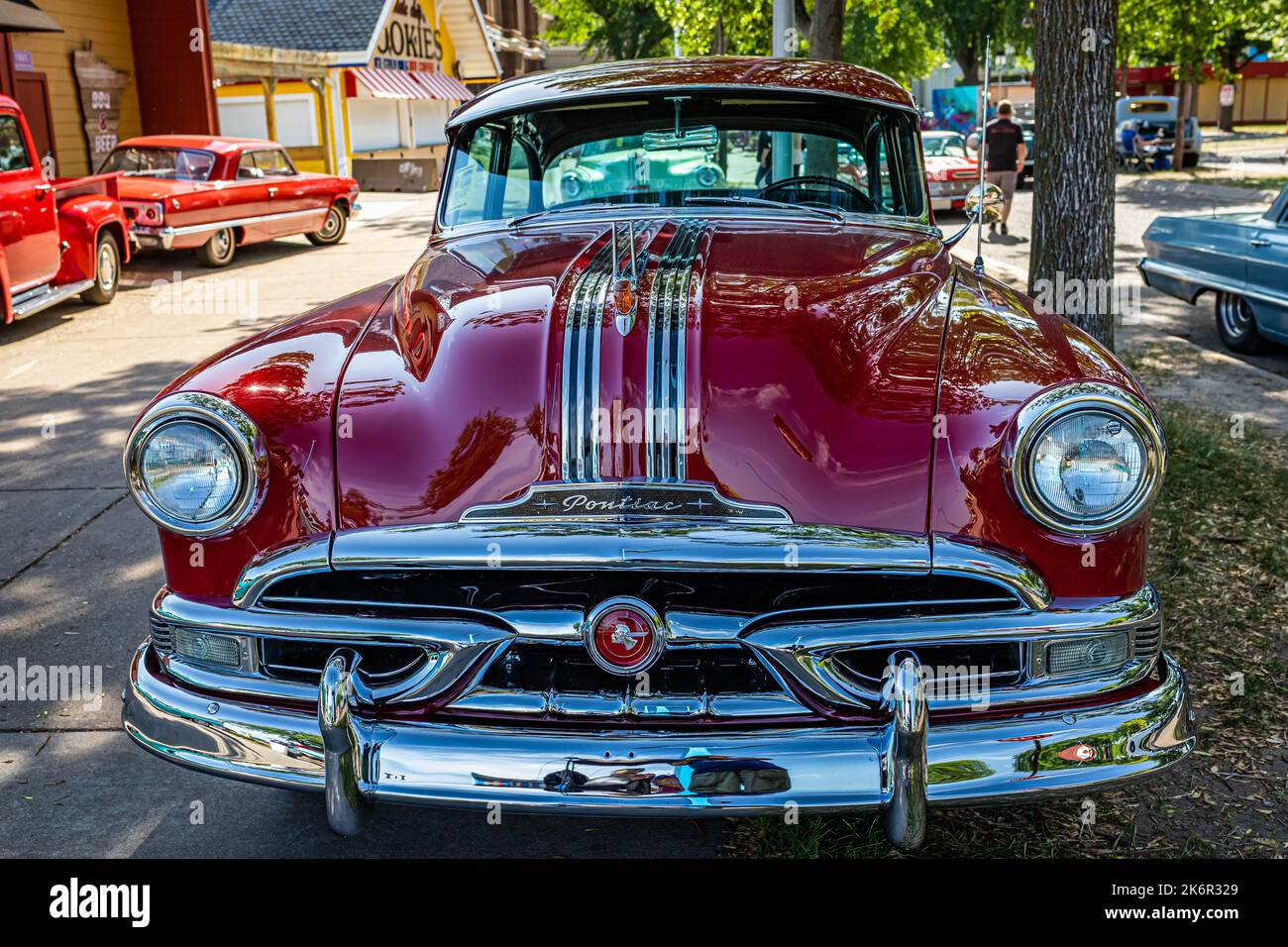Falcon Heights, MN - June 19, 2022: Wide angle high perspective front view of a 1953 Pontiac Chieftain 2 Door Sedan at a local car show. Stock Photo