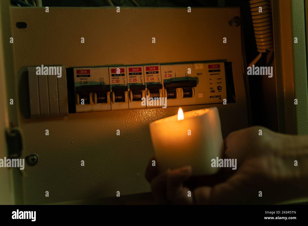 UKRAINE, Kyiv - OCT 15, 2022: Power switch darkness blackout no electricity box candle green, from, nergy dark crisis Stock Photo