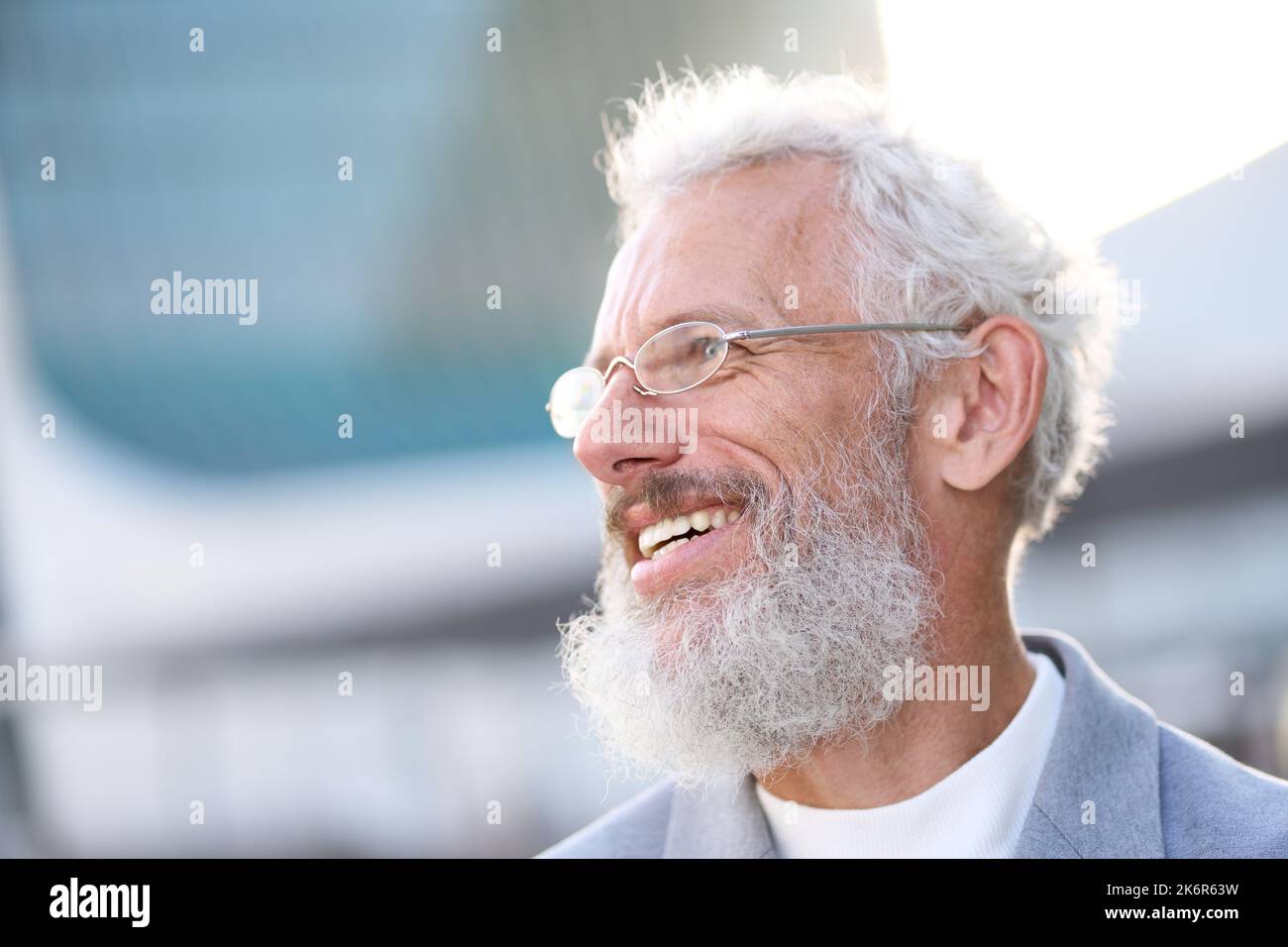 Smiling happy senior old business man wearing suit outdoor headshot portrait. Stock Photo