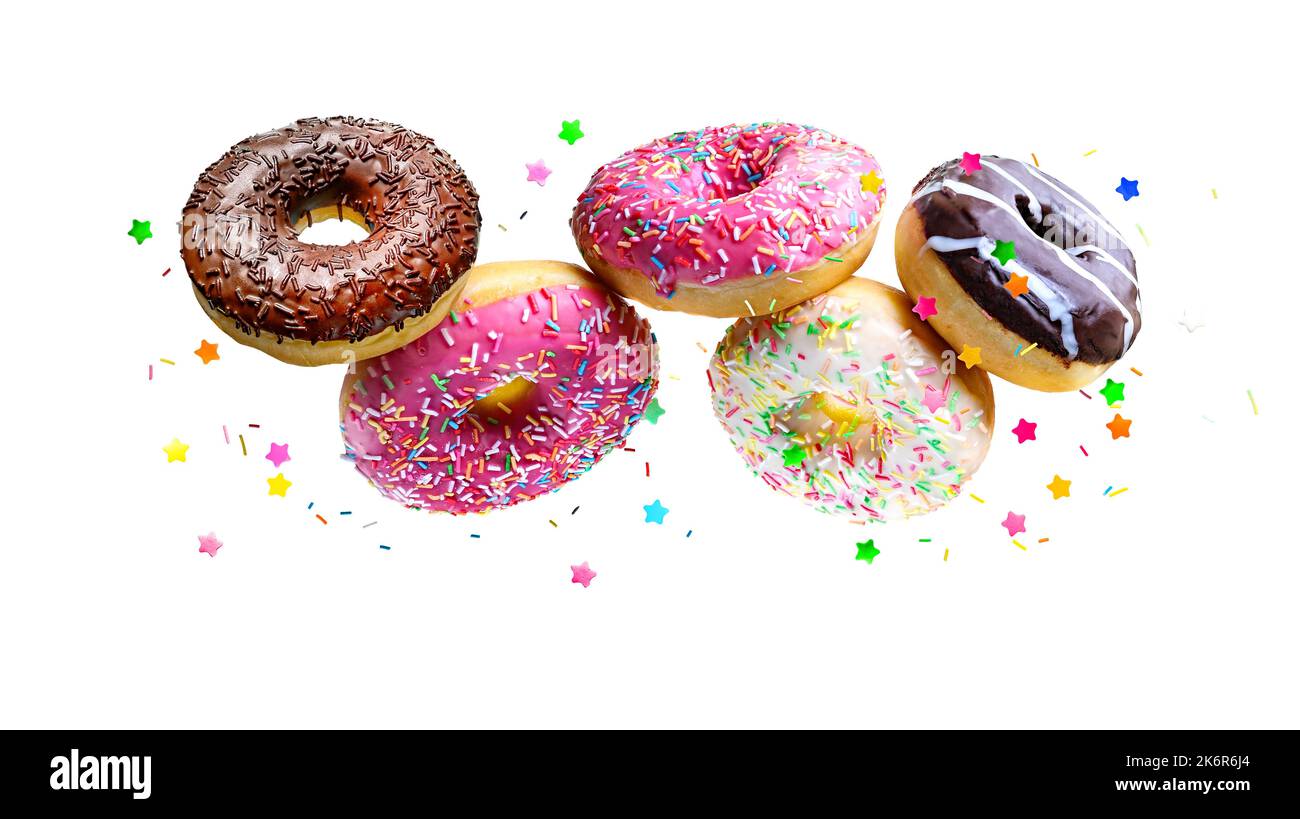 Flying glazed donuts isolated over white background. Stock Photo