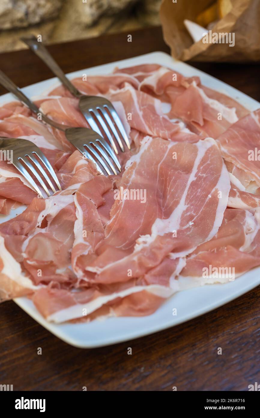 Prosciutto di San Daniele Crude Italian Ham on a Plate from Friuli, Italy Stock Photo
