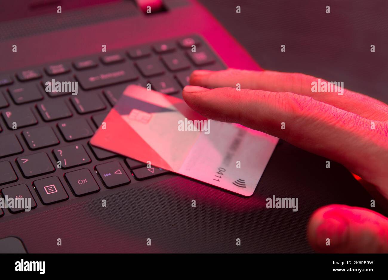 Computer hacker trying to steal money from card - bank card and laptop ...