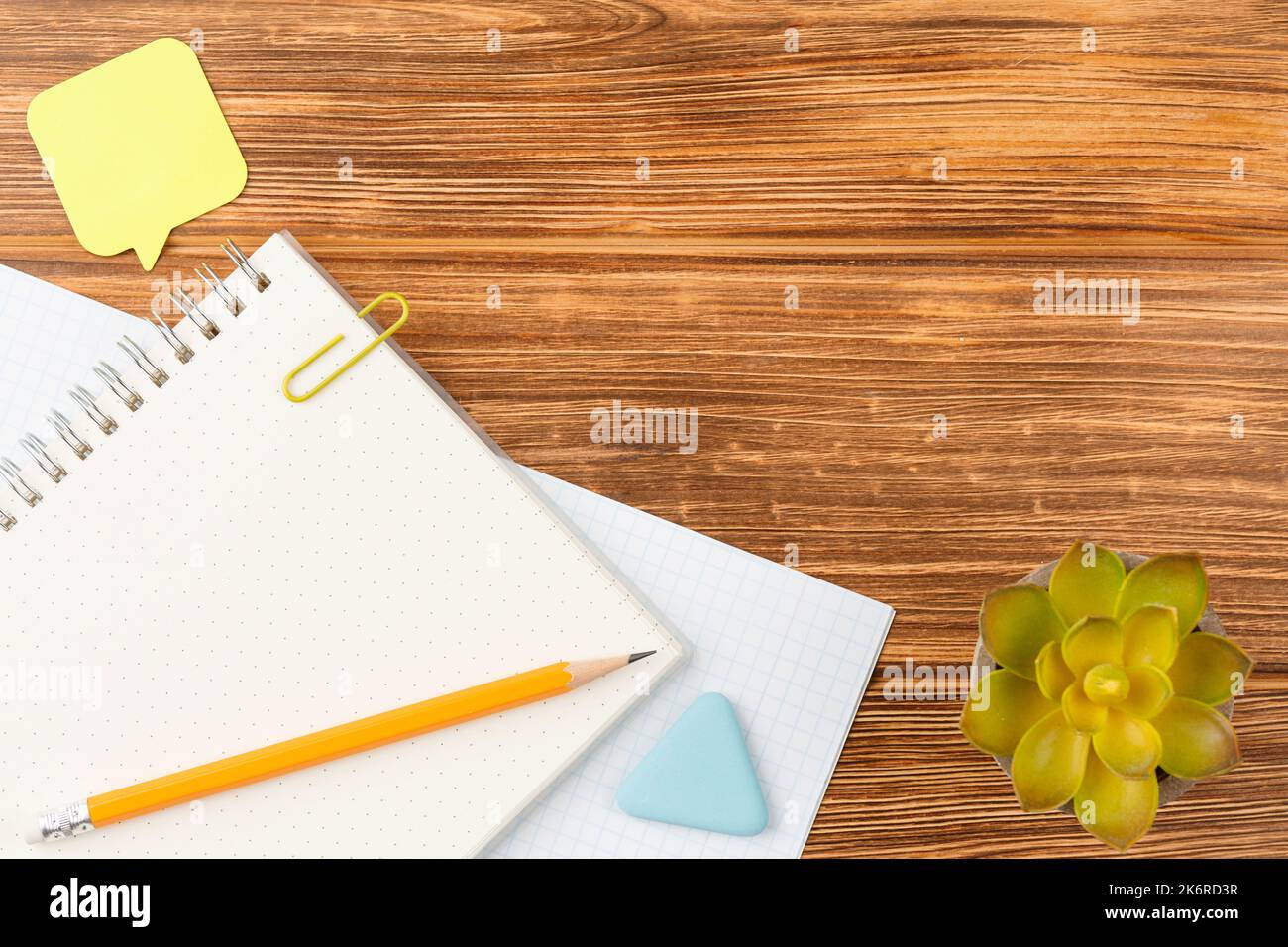 Notepad with school supplies on a wooden desk. Stock Photo