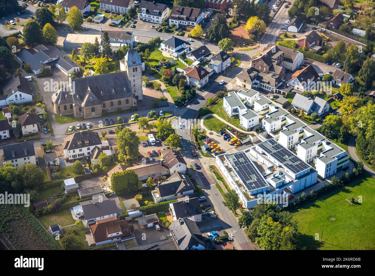 Aerial view, new construction housing estate Heidestraße, apartments suitable for elderly people, church St. Maria Magdalena, Holzen, Menden, Ruhr are Stock Photo