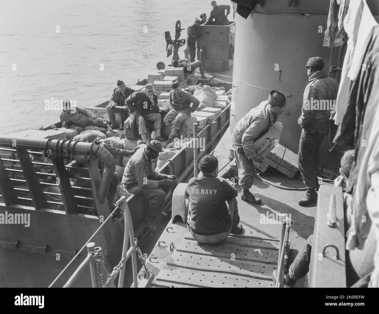Photograph of Army Men Loading Landing Craft with Food Supplies at an