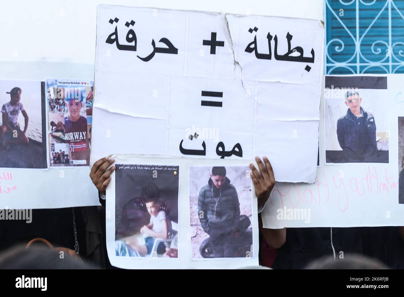 Zarzis, Tunisia. 14th Oct, 2022. Friends and families hold pictures of disappeared migrants who were on a boat that sank as a protest in Zarzis, Tunisia, on October 14, 2022.Local citizens accuse the authorities of having disrespected the families of the dead, some having been buried in the cemetery of “anonymous” without any identification. (Photograph by Mohamed Krit/Sipa USA) Credit: Sipa USA/Alamy Live News Stock Photo