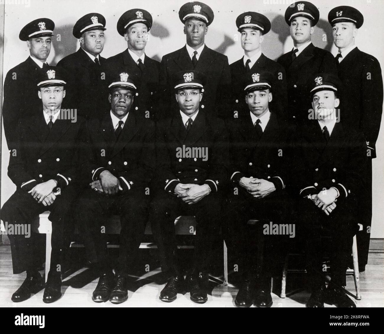 Men Recently Appointed to the Temporary Rank of Ensign D-V(S)'Eleven of these men were recently appointed to the temporary rank of Ensign D-V(S), and one to Warrant Officer, USNR. Left to right - Front row: Ensigns George Clinton Cooper, Graham Edward Martin, Jesse Walter Arbor, John Reagan, Reginald Ernest Goodwin. Back row: Dennis Denmark Nelson, Phillip George Barnes, Samuel Edward Barnes, D. L. Baugh, James Edward Hare, Frank Ellis Sublett, and Warrant Officer Charles Byrd Lear.'. Stock Photo