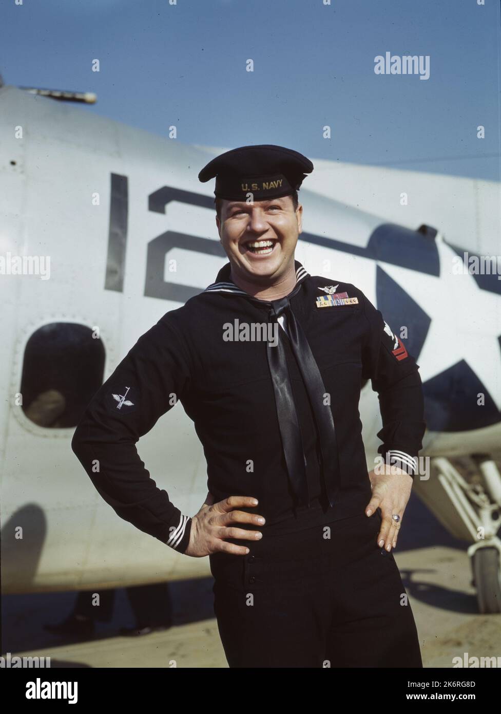 'Jack Cain, AM2/C, USN, is shown in dress blues with campaign ribbons and three battle stars.' Caption on Negative Sleeve: 'Jack Cain, AM2/c, USN, aerial gunner, poses in dress blues show three battle stars on campaign ribbons.'. Stock Photo