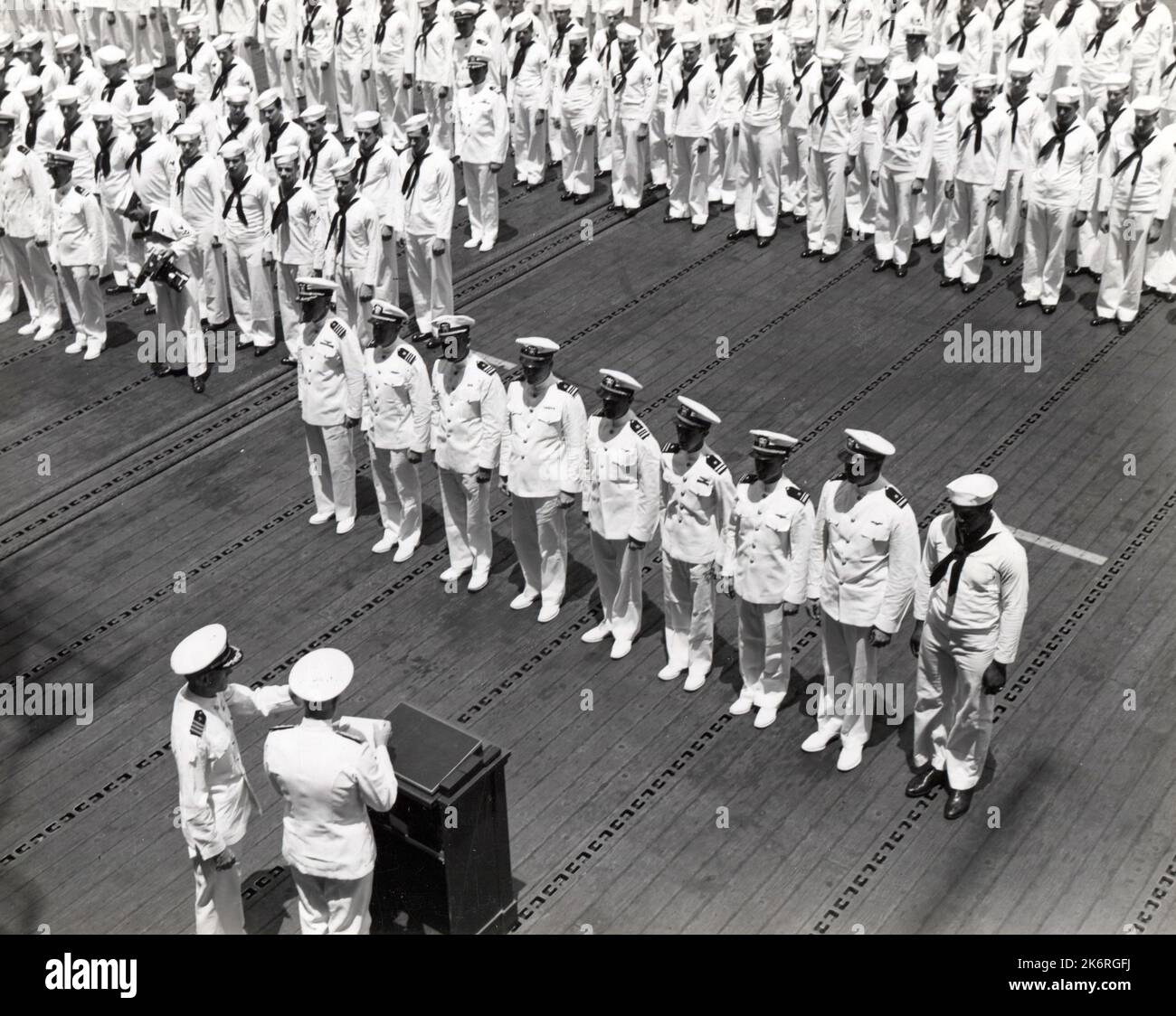 Naval Officers and Enlisted Men Await Presentation of Individual Heroism'Naval officers and enlisted men await presentation of individual heroism awards by Adm. Chest W. Nimitz at Pearl Harbor. The ceremony was held on the flight deck of the USS Enterprise (CV-6).' Photographer: USS Enterprise. Stock Photo