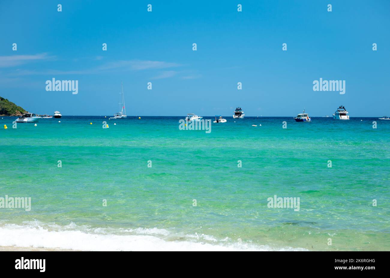 Crystal clear blue water of  legendary Pampelonne beach near Saint-Tropez, summer vacation on white sandy beach of French Riviera, France Stock Photo