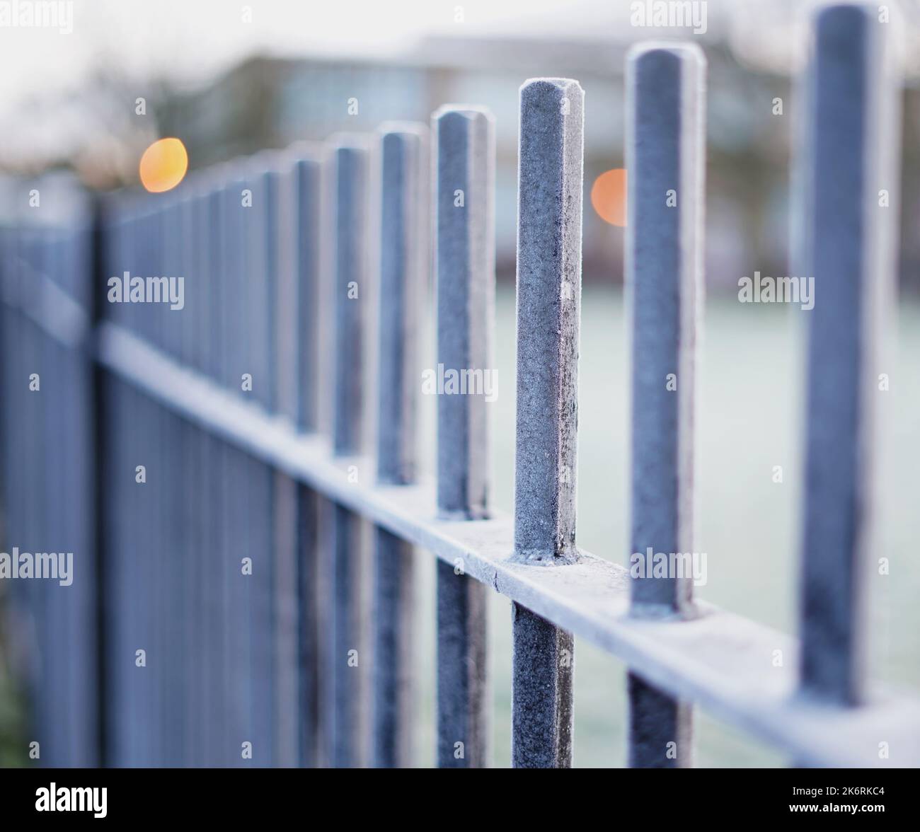 Cold, frosty metal railings dissapearing into the distance early on a ...