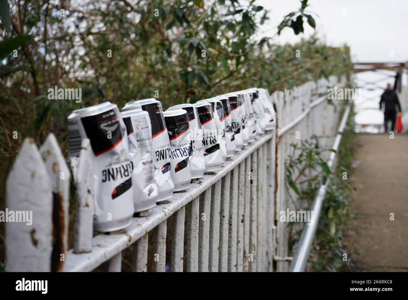 Row of upturned empty Carling beer cans on railings on a bridge. Stock Photo