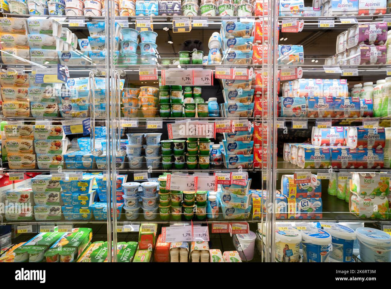 Fossano, Italy - October 14, 2022: refrigerator shelf with packages of yoghurt of various brands for sale in italian supermarket Stock Photo