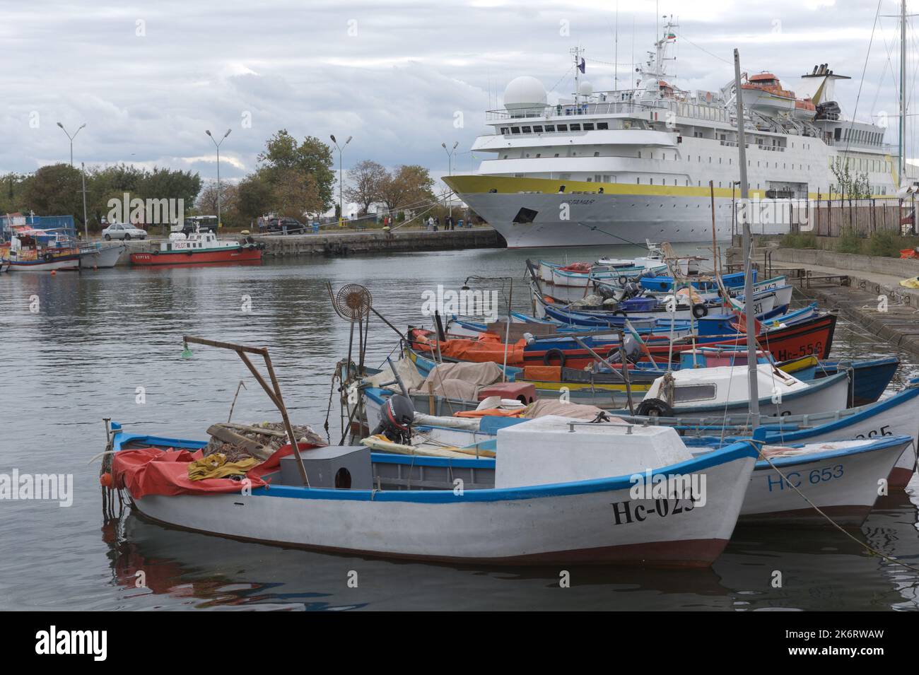 Fishing boats against the passenger ship Vistamar in the port of Nessebar, Bulgaria Stock Photo