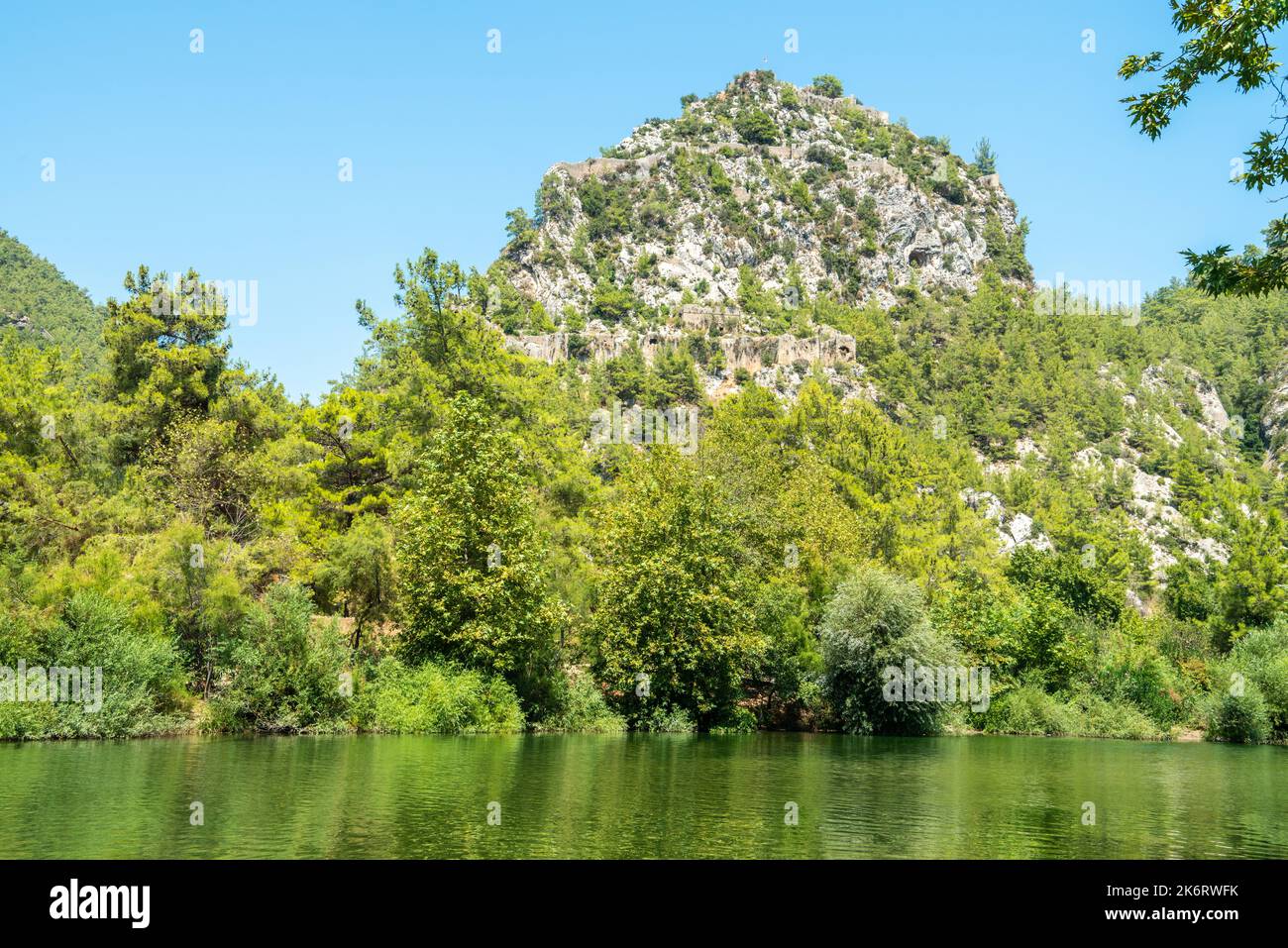 Alara River and a massive rocky hill with the ruins of Alara Castle in Alanya, Turkey. The castle dates from the 13th century. Stock Photo