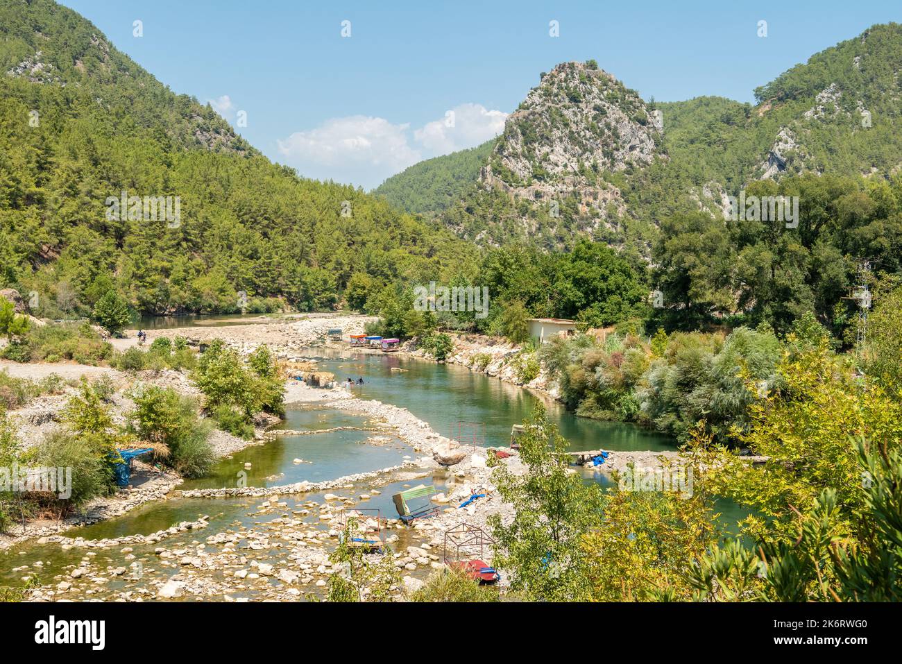 Alara (Uluguney) River running among mountains near Alanya, Turkey. View with basic picnic facilities and people, in summer. Stock Photo