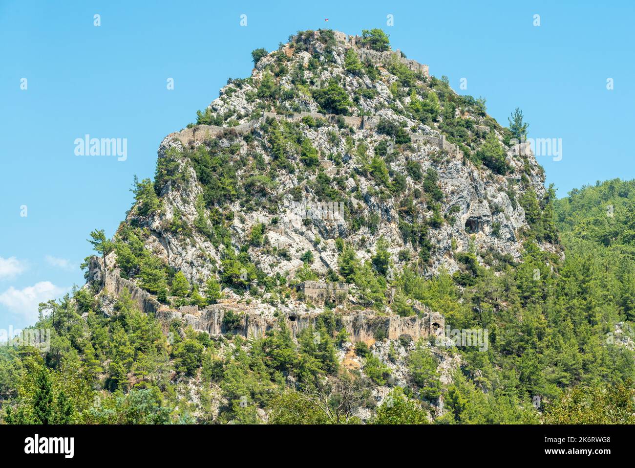 A massive rocky hill with the ruins of Alara Castle in Alanya, Turkey. The castle dates from the 13th century. Stock Photo