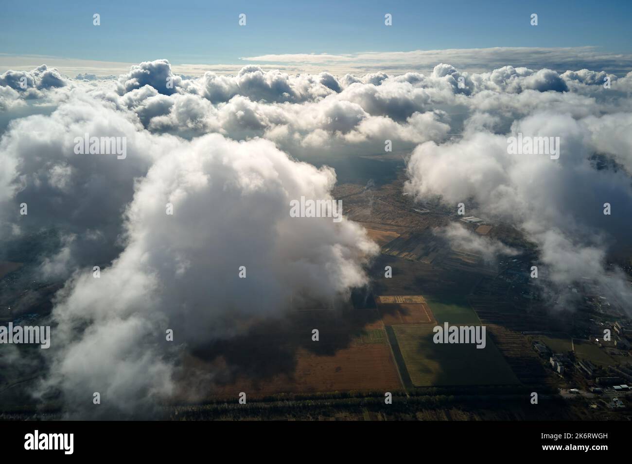 Aerial view at high altitude of earth covered with puffy cumulus clouds ...