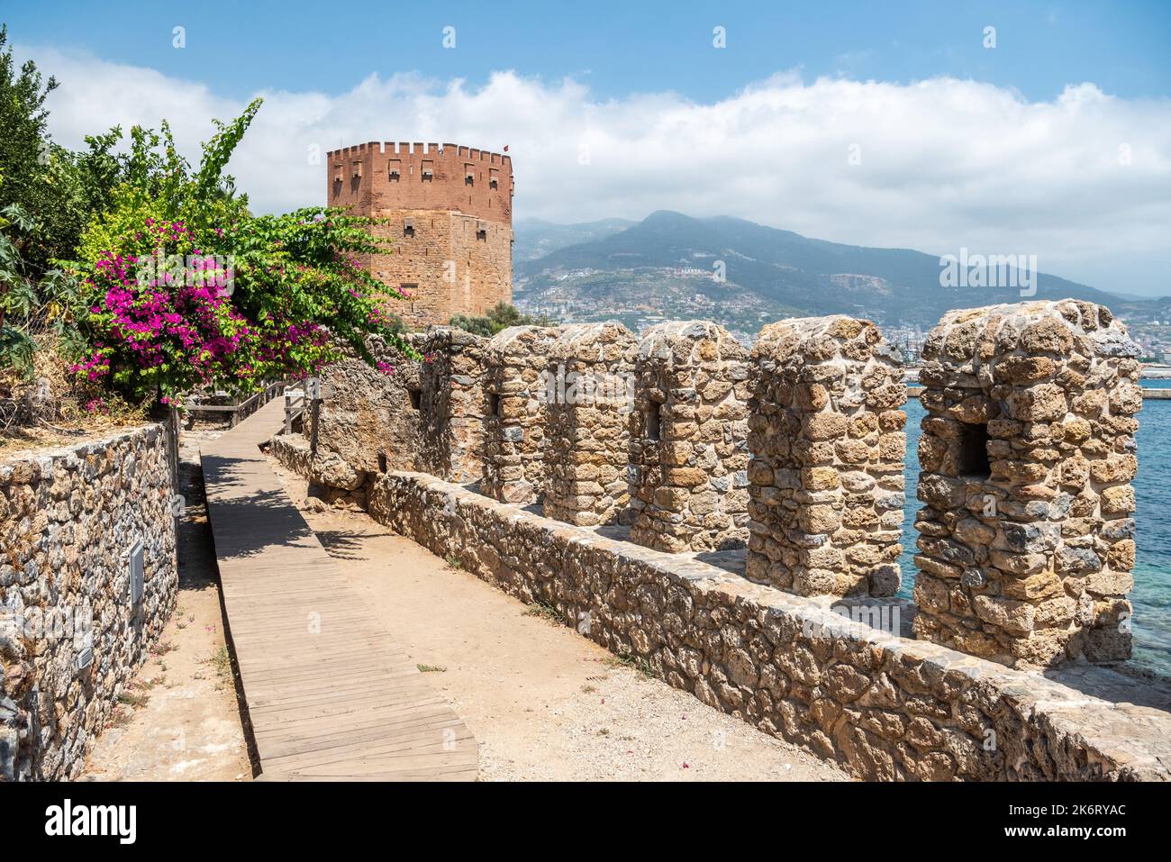 Alanya, Turkey – August 18, 2021. View of old harbour walls and Red Tower in Alanya, Turkey. The five-storey octagonal defence tower was constructed i Stock Photo