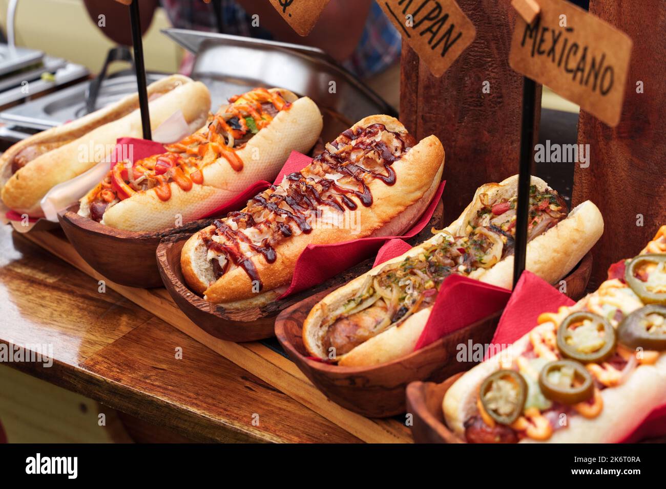 Many hot dogs with various toppings and sauces. Grilled hot dog sausage ...