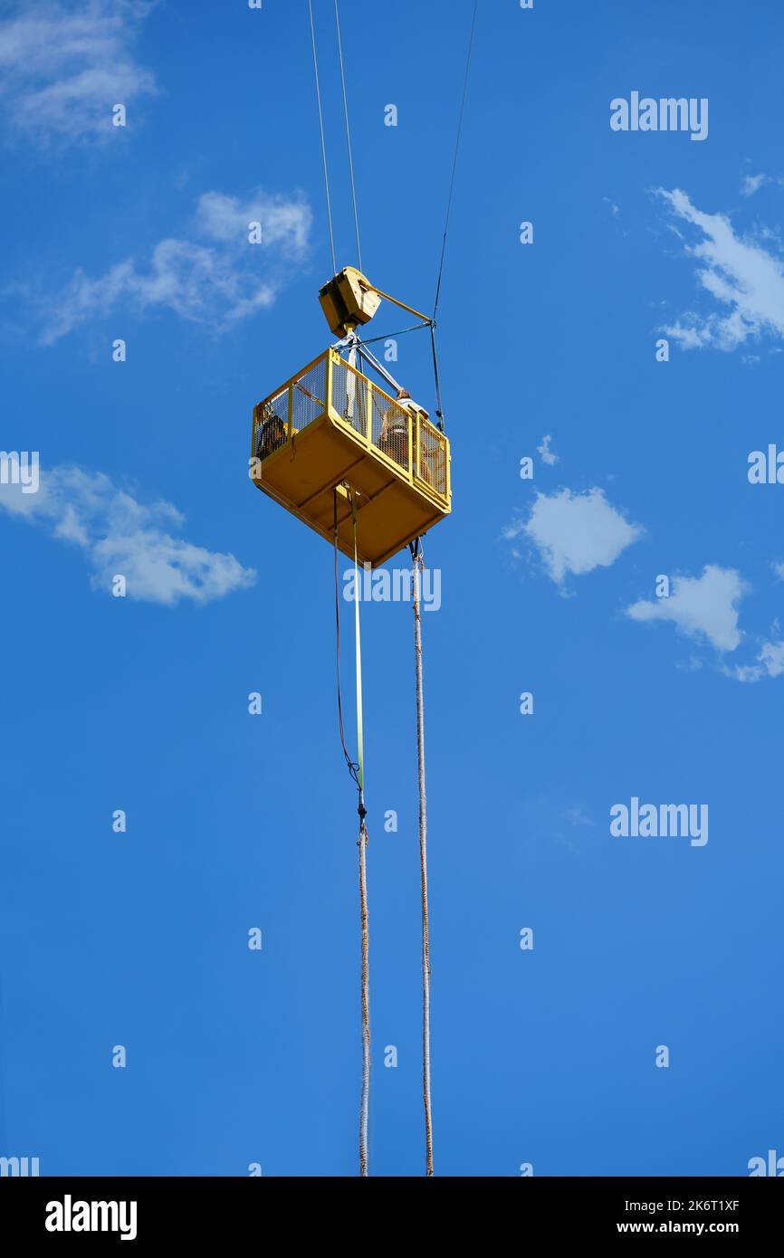 An extreme sportsman jumps on a rope from a crane. bungee jump in sunny