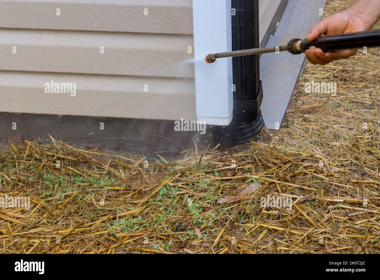 Service that involves cleaning siding houses by using high pressure nozzles spray water soap cleaner Stock Photo