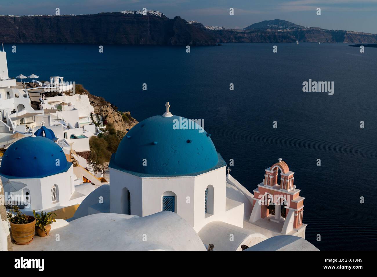 View of the town of Oia with its limewashed houses and churches with blue domes. Santorini is one of the Cyclades islands in the Aegean Sea known for Stock Photo
