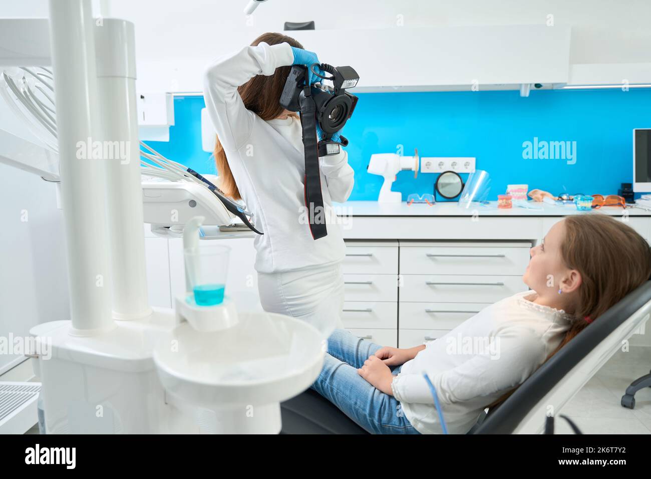 Pediatric dentist taking dental photos of young patient Stock Photo