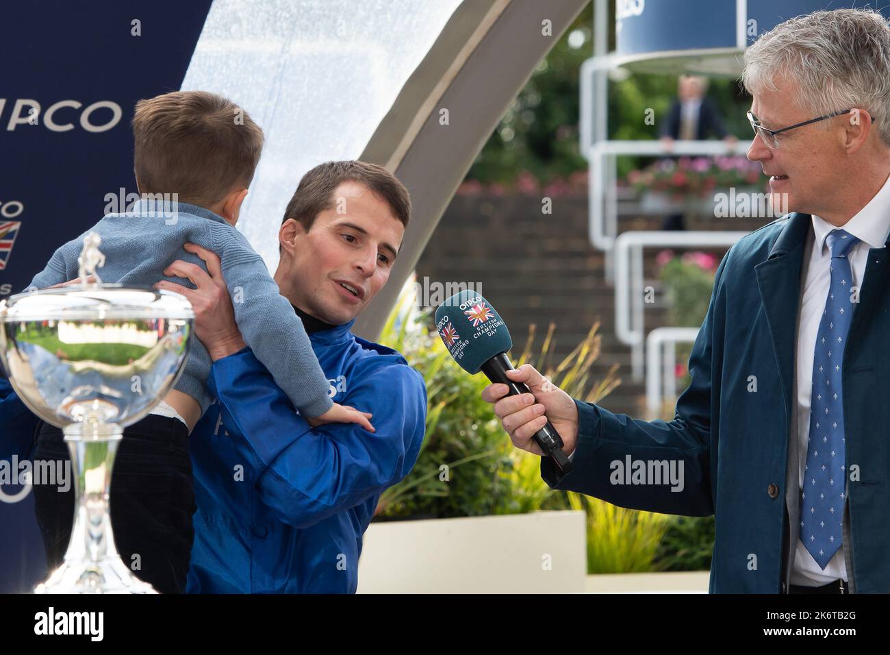 Ascot, Berkshire, UK. 15th October, 2022. William Buick realised a long-held ambition at Ascot today as he was crowned Champion Jockey for the first time. Racing legend Willie Carson presented him with the trophy. The 34-year-old has dominated the championship from the outset and begins the final day of the season on 157 winners, 67 clear of his closest challengers Hollie Doyle and Tom Marquand. Credit: Maureen McLean/Alamy Live News Stock Photo