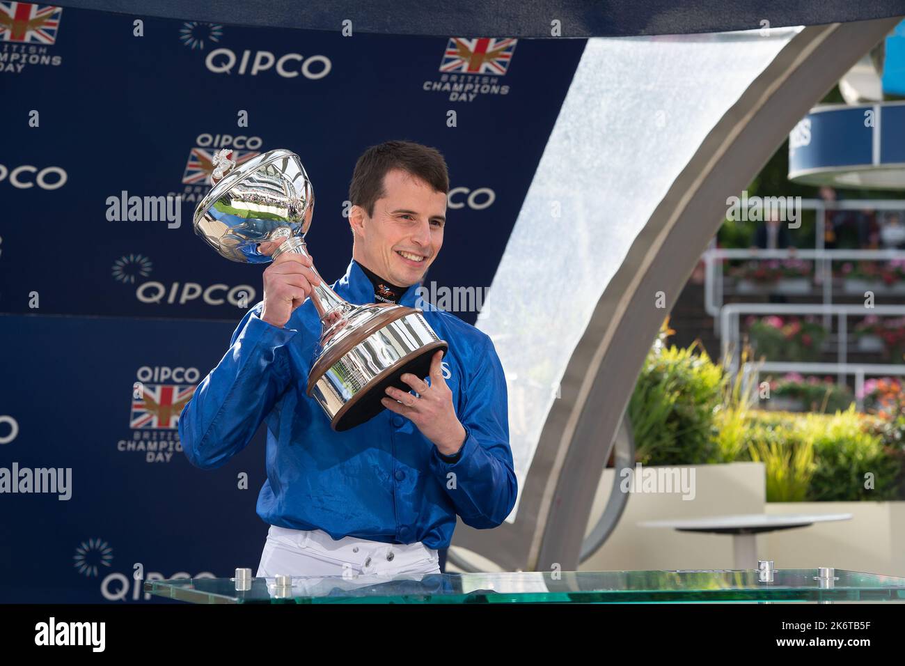 Ascot, Berkshire, UK. 15th October, 2022. William Buick realised a long-held ambition at Ascot today as he was crowned Champion Jockey for the first time. Racing legend Willie Carson presented him with the trophy. The 34-year-old has dominated the championship from the outset and begins the final day of the season on 157 winners, 67 clear of his closest challengers Hollie Doyle and Tom Marquand. Credit: Maureen McLean/Alamy Live News Stock Photo