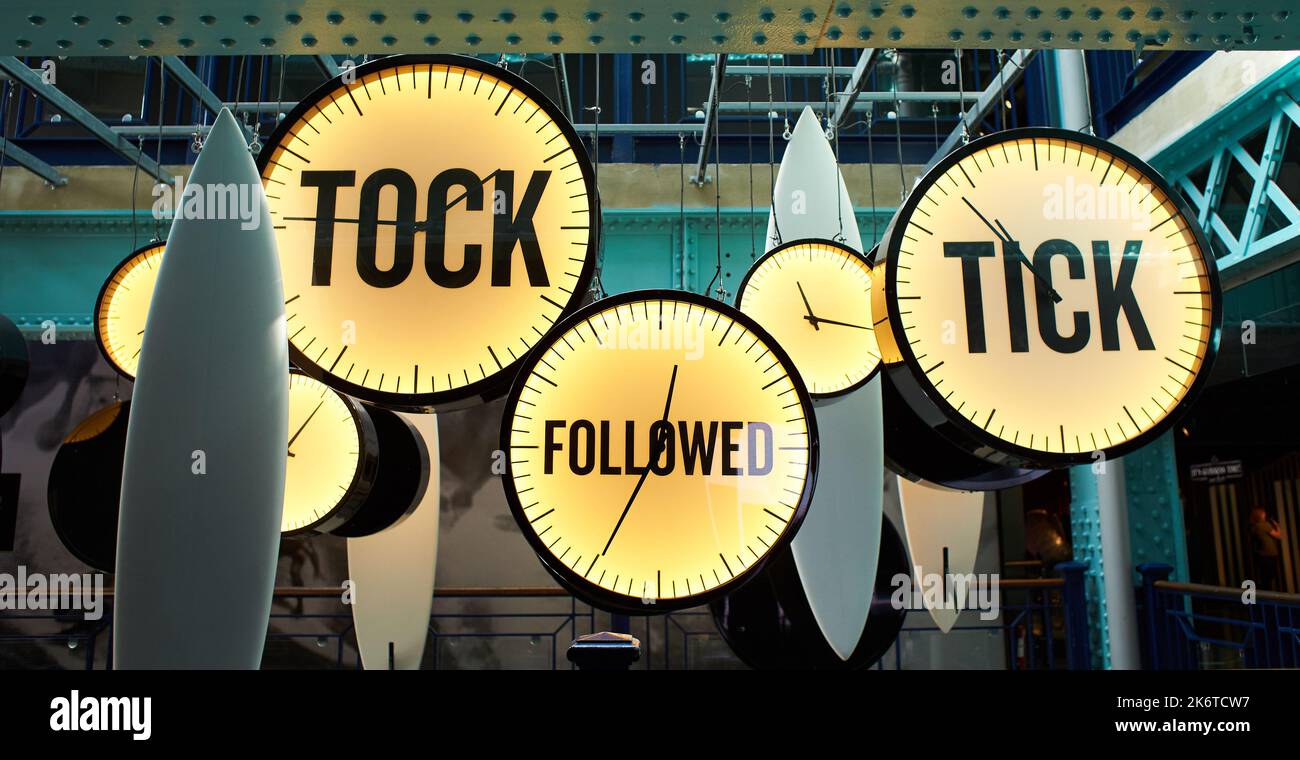 Clocks with inscriptions 'tik, tok and followed'.Yellow and blue Stock