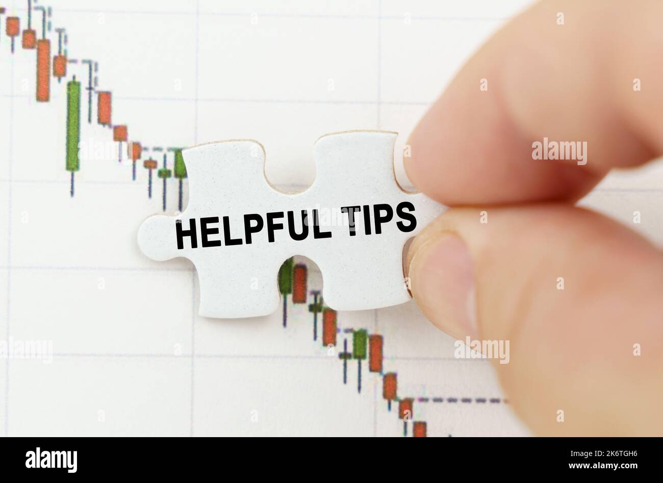 Business concept. Against the background of the quotes chart, a puzzle with the inscription - Helpful Tips Stock Photo