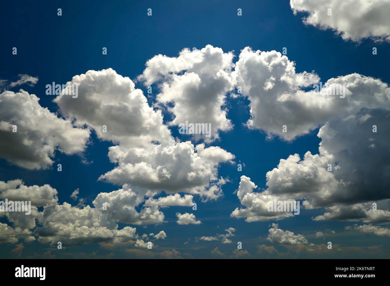 White puffy cumulus clouds on summer blue sky Stock Photo - Alamy