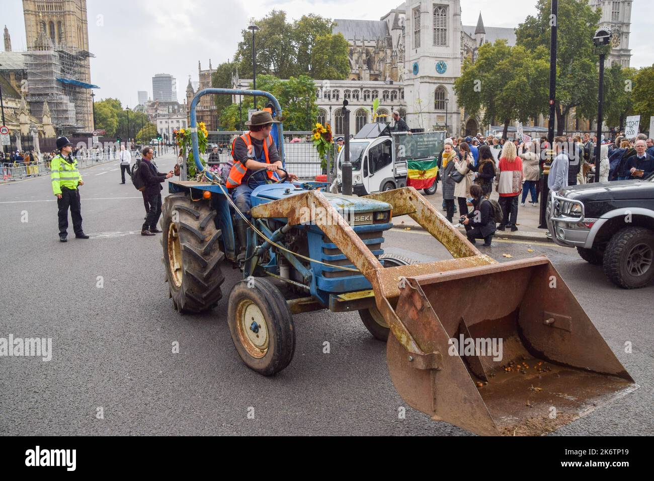 London, UK. 15th Oct, 2022. A protester drives a tractor during the march in Parliament Square. Farmers and supporters marched in Westminster demanding a better food and farming system in the UK, to save environmental land management schemes, and to protect nature. Credit: SOPA Images Limited/Alamy Live News Stock Photo