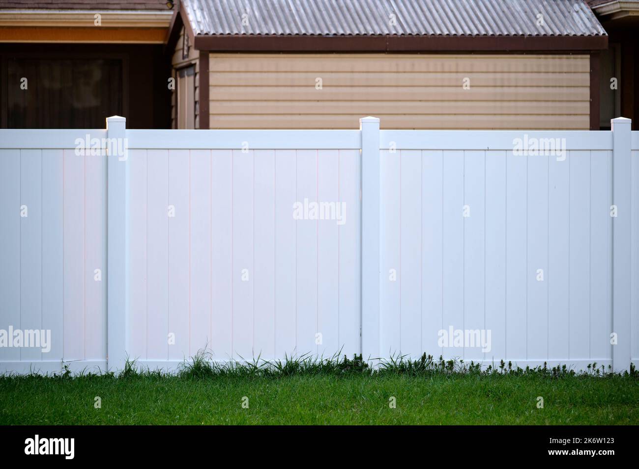 White plastic fence for back yard protection and privacy Stock Photo
