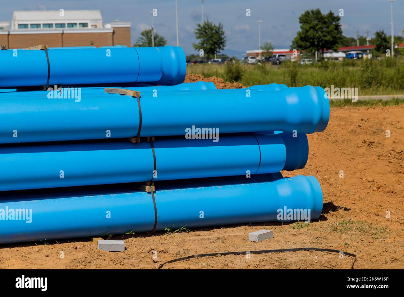 On construction site for new house, blue plastic PVS pipes were introduced to drainage of septic system to home Stock Photo