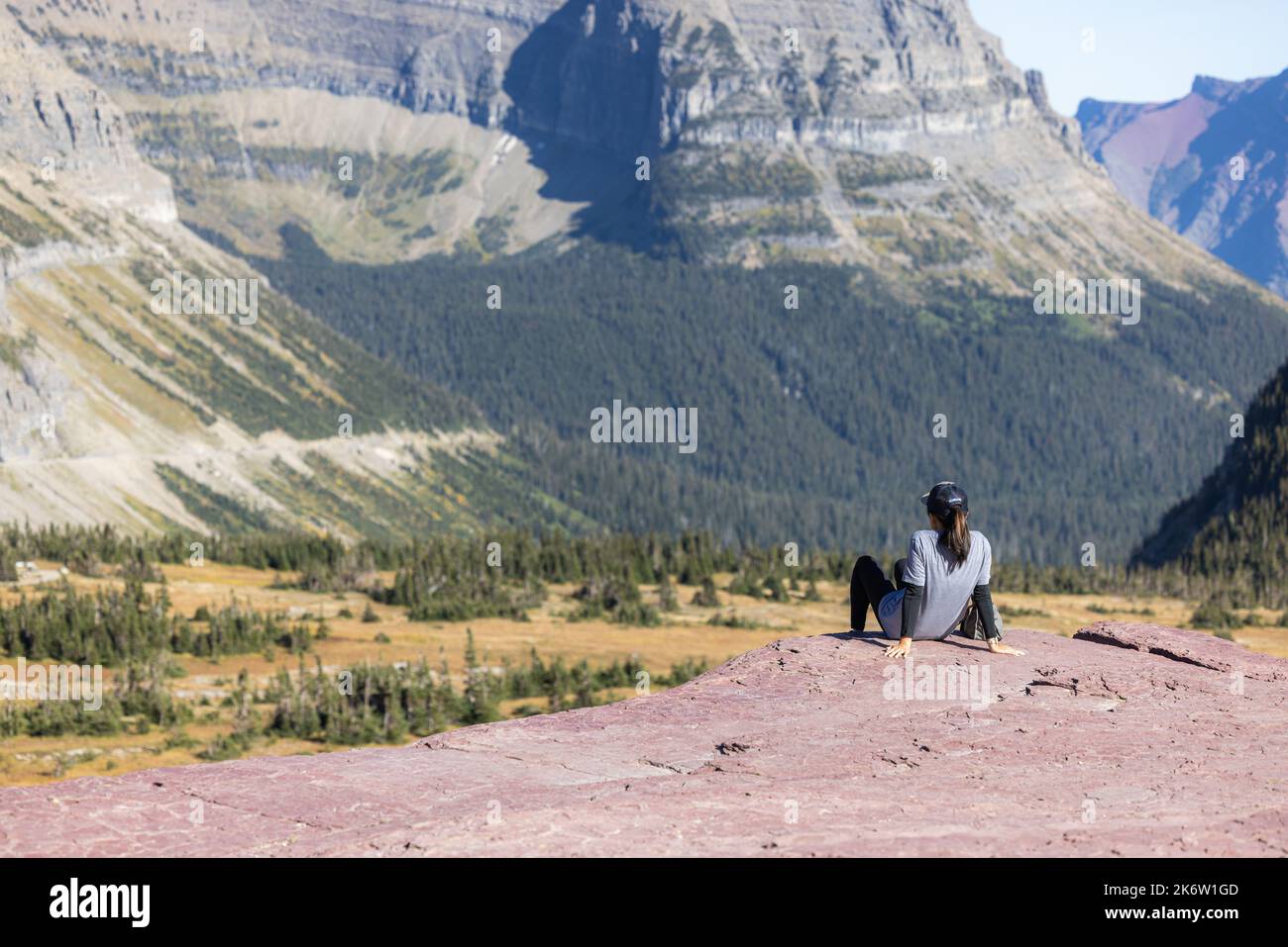 Glacier National Park, Montana USA - September 26 2022: hiker enjoying the breathtaking view from the Hidden Lake trail on top of Logan Pass Stock Photo